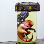 Intense 'D-Rex Breaks Containment' artwork featuring a terrifying dinosaur escaping a futuristic laboratory.